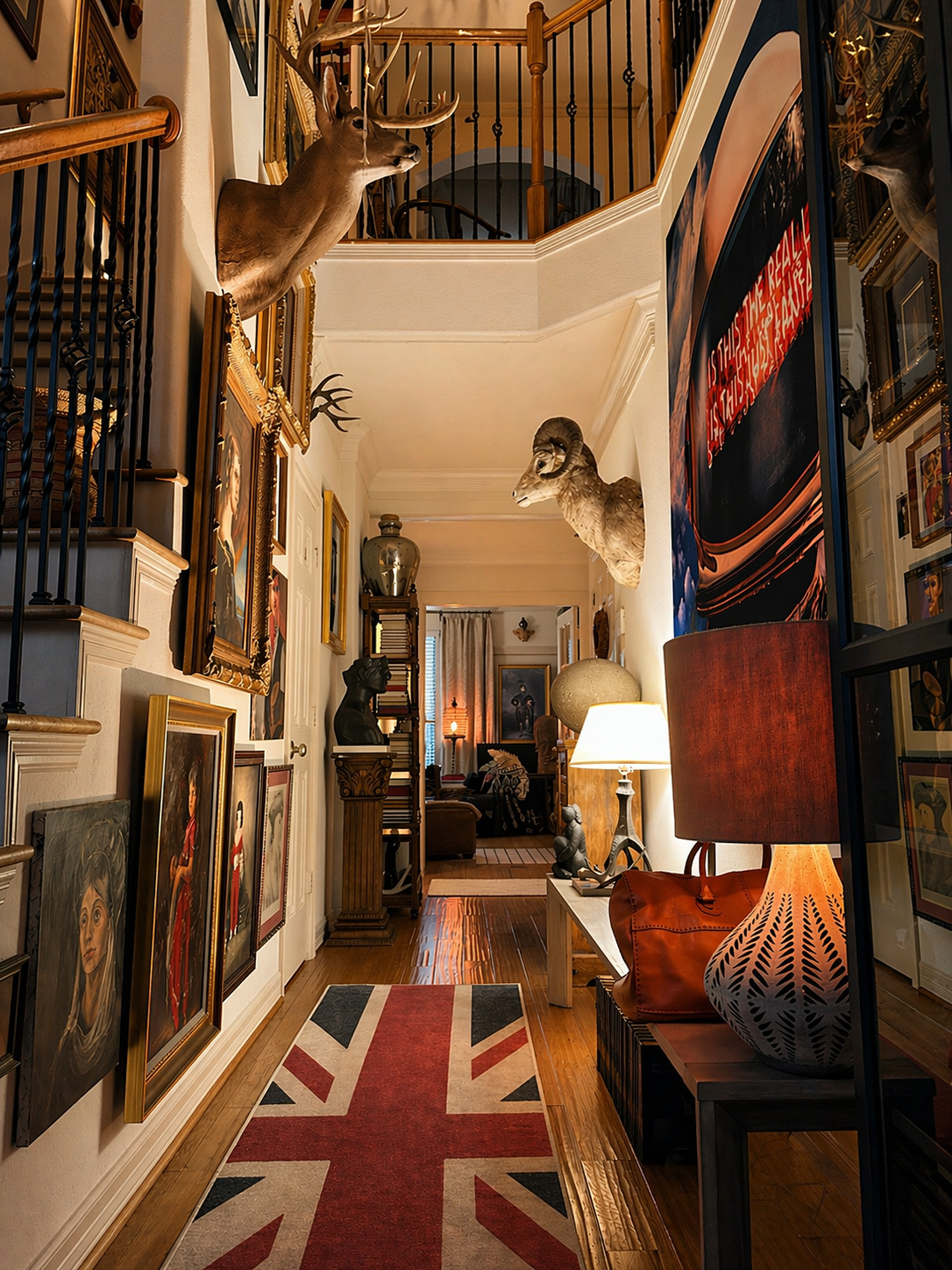 Grand 3 story entry hall filled with art and rare objects and book by This Is Home Studio in Houston, Texas and designed by Luke and Alejandra Fortin. 