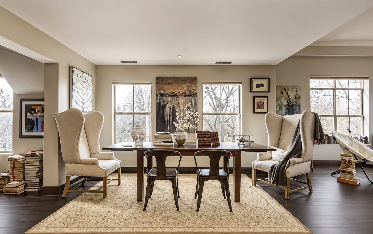 Penthouse dining and library room by This Is Home Studio in Houston, Texas and designed by Luke and Alejandra Fortin. Modern design featuring original paintings and art.